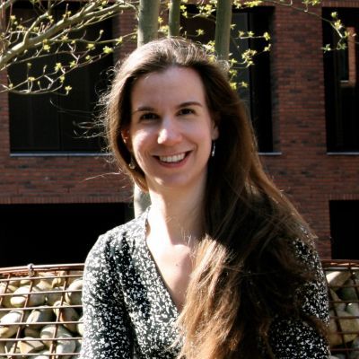 Anemone Van Zijl, white woman, smiling with long hair, tree in background